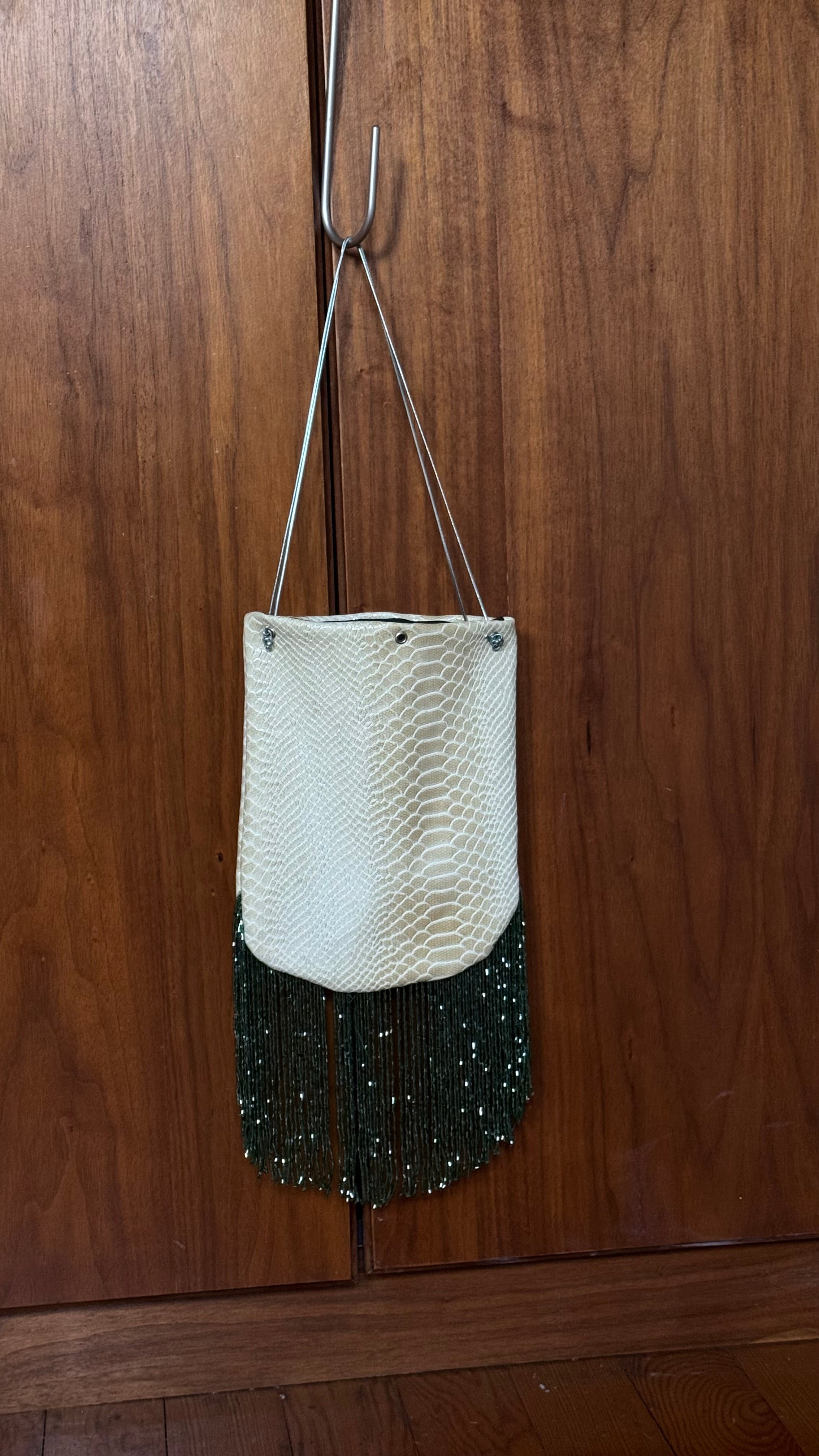 Snake print fringed bucket bag
