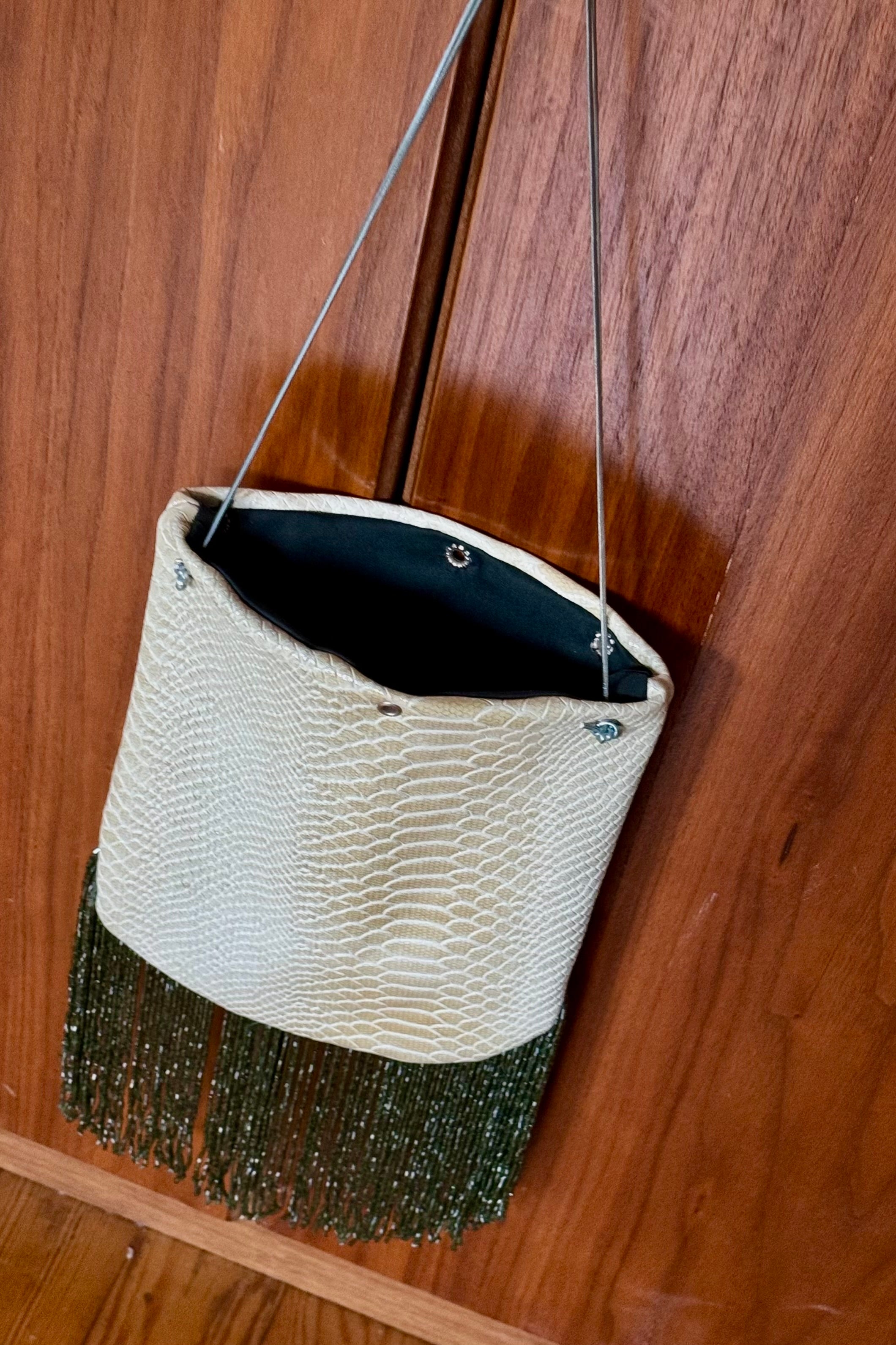 Snake print fringed bucket bag