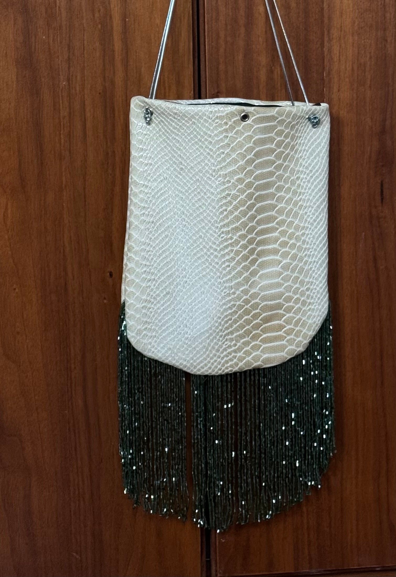 Snake print fringed bucket bag